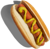 Classic hot dog with yellow mustard zigzagged on top, served in a light-colored bun with a soft shadow