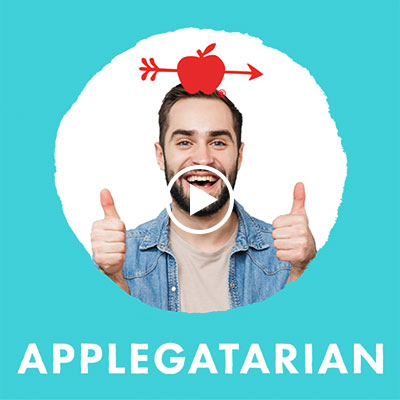 Smiling person in denim jacket giving thumbs up, with Applegate apple logo, against teal background